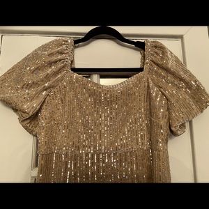 A cocktail dress in a soft tan velour with silver sequins.